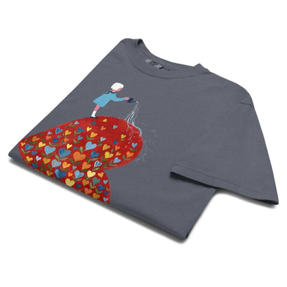 Denim blue t-shirt with a colorful heart design and person pouring water onto it on a white background