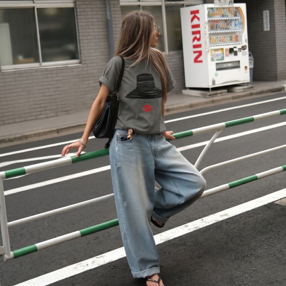 Woman crossing a street with aKirin vending machine in the background