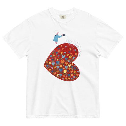 White t-shirt with a colorful heart design and small figure on a white background