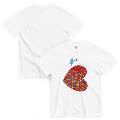 White t-shirt with a colorful heart design and small figure on a white background