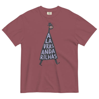 A dusty rose short-sleeve crewneck t-shirt featuring a graphic of a walking figure made of the letters 'A L A V R A S A N D A R I L H A S' in white on a black triangle, with a small eye at the top and a black hat. The shirt is displayed flat against a solid white background.