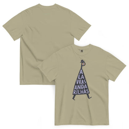 A light khaki-beige short-sleeve t-shirt shown from both the front and back. The front features a graphic of a dark purple inverted triangle with the text 'A LA VRAIS ANDA RILHAS' written vertically inside, topped with a small dark purple hat.