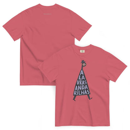 A coral pink short-sleeve t-shirt shown from both front and back. The front features a graphic of a black silhouette figure inside a triangle with the text 'A LA VRAS ANDA RILHAS' in white.