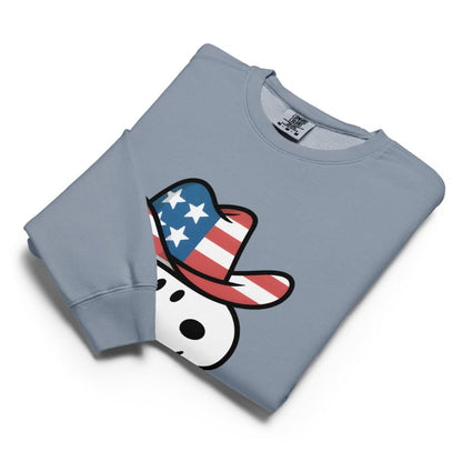 Folded blue sweatshirt with a graphic of a dog wearing an American flag hat on a white background