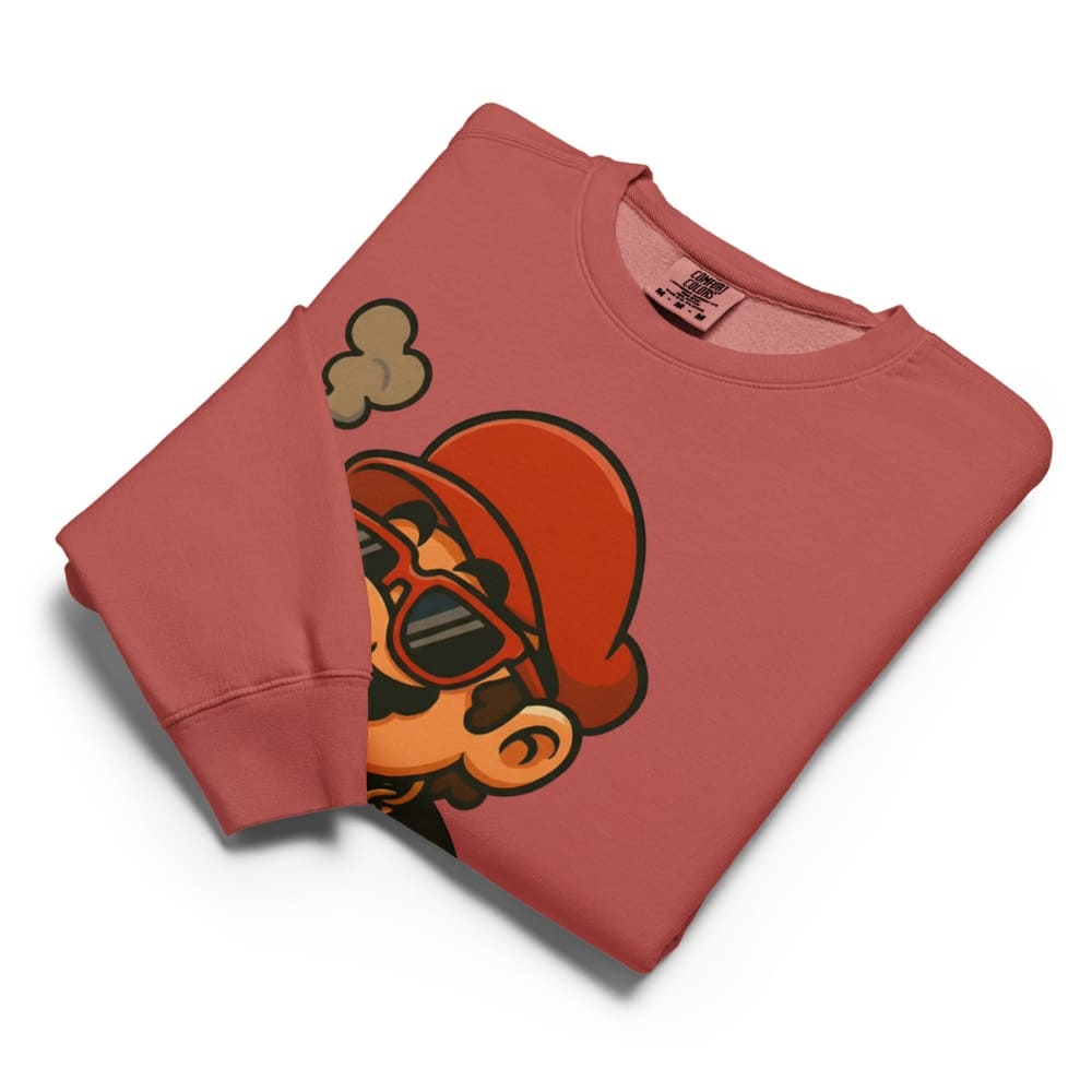 Folded red sweatshirt with a graphic design on a white background