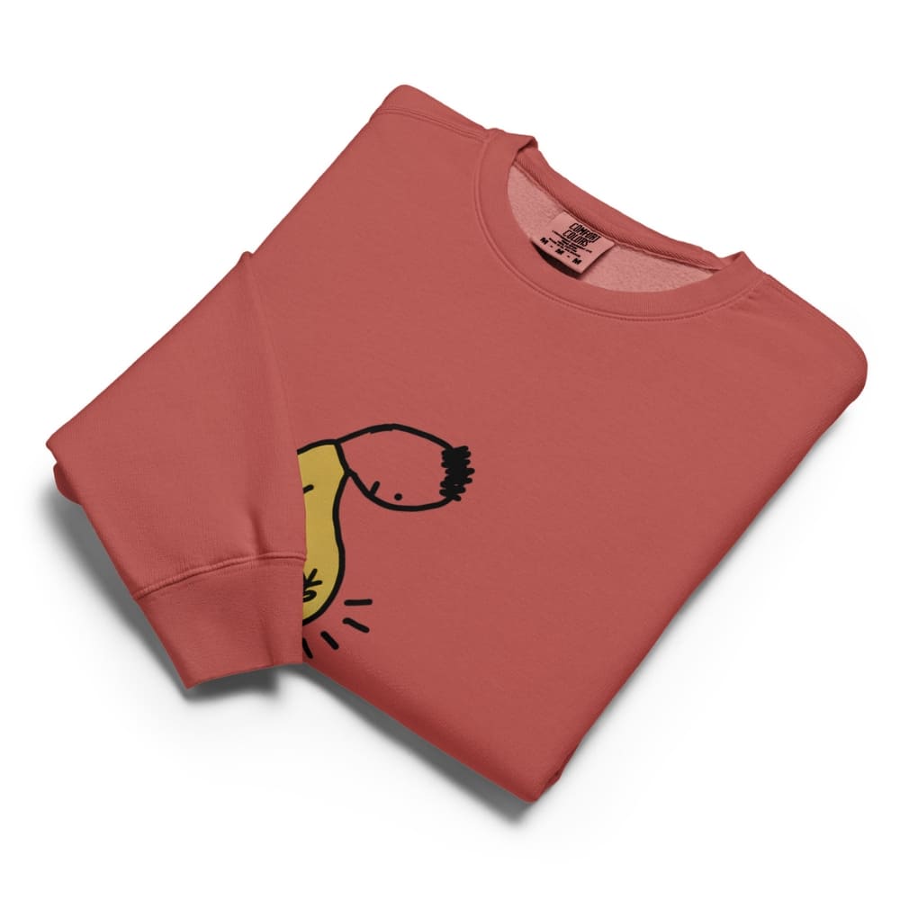 Folded red sweatshirt with a yellow graphic on a white background