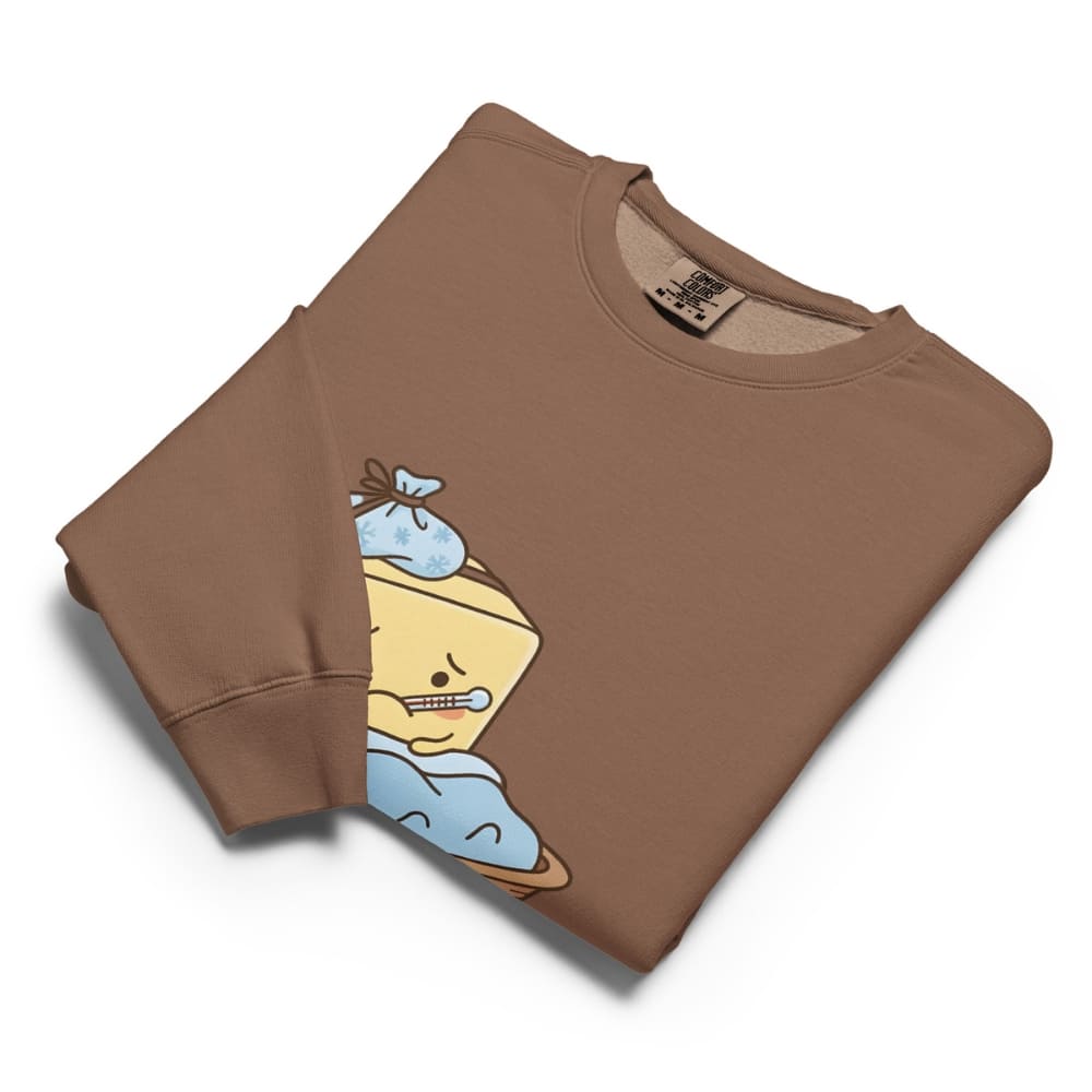 Folded brown sweatshirt with cartoon character design on a white background
