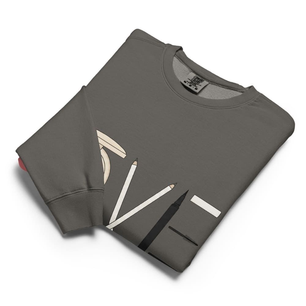 Folded gray sweatshirt with pencil design on a white background