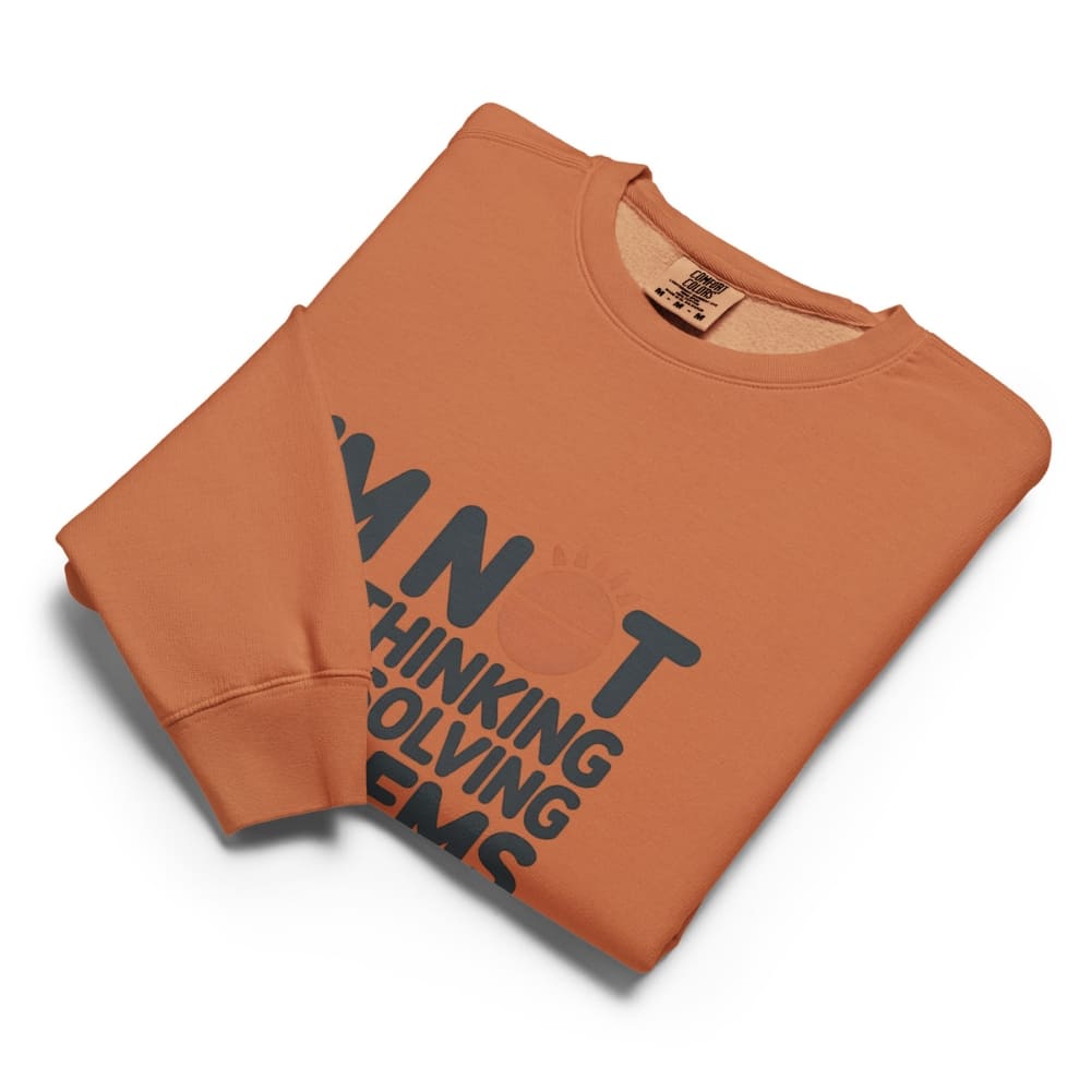 Folded orange sweatshirt with black text on a white background