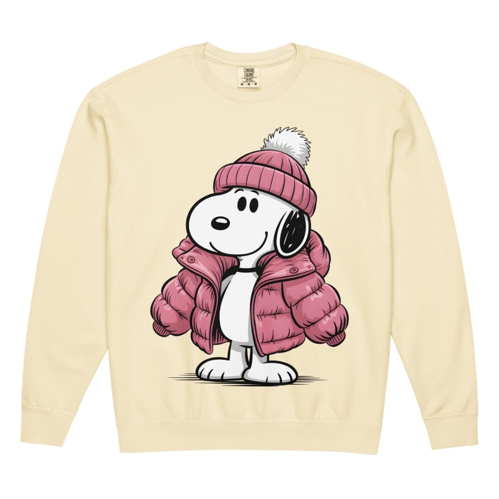 Snoopy wearing a pink winter coat and hat on a beige sweatshirt.