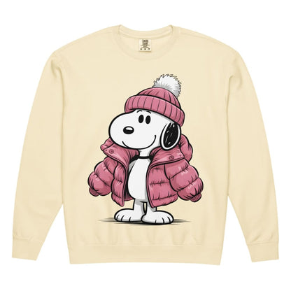 Snoopy wearing a pink winter coat and hat on a beige sweatshirt.