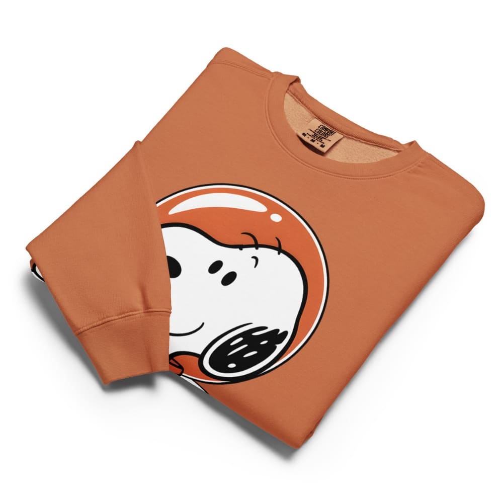 Folded orange sweatshirt with a cartoon character design on a white background