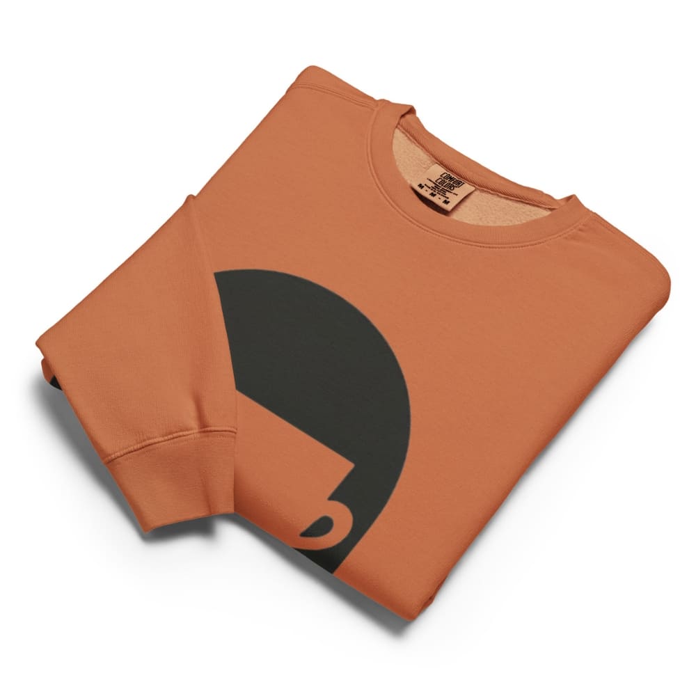 Folded orange sweatshirt with a black graphic on a white background