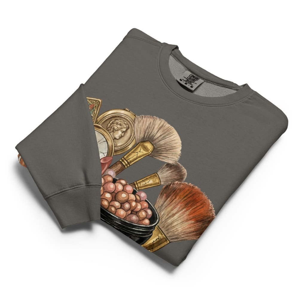 Folded gray sweatshirt with decorative design of brushes and decorative elements on a white background