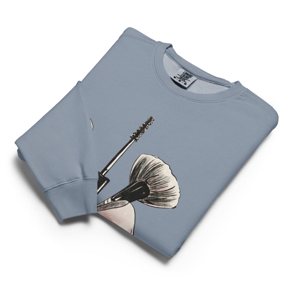 Folded light blue sweatshirt with a graphic design on a white background
