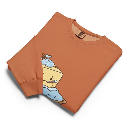 Folded orange sweatshirt with cartoon character design on a white background
