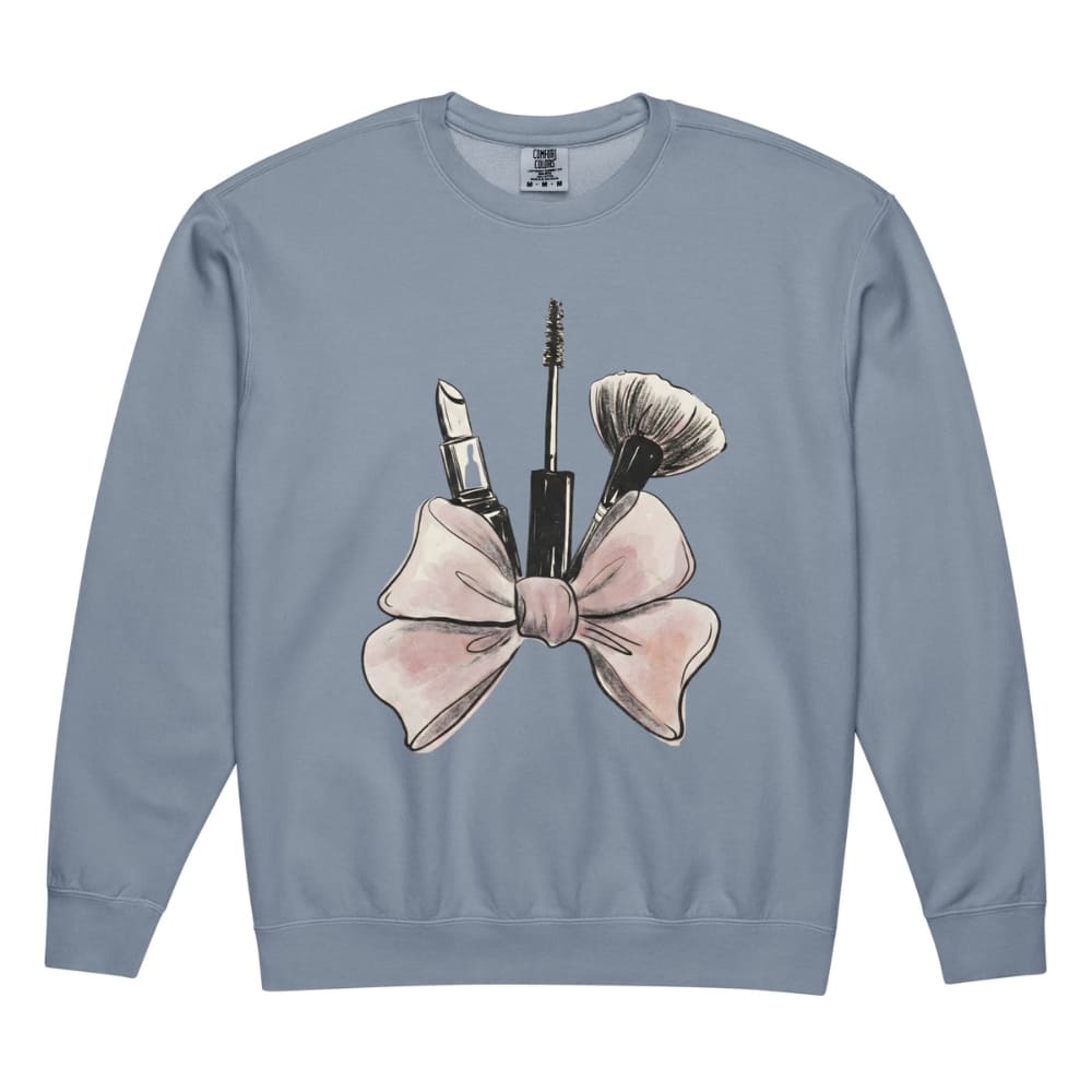 Blue sweatshirt with makeup and bow design on a white background