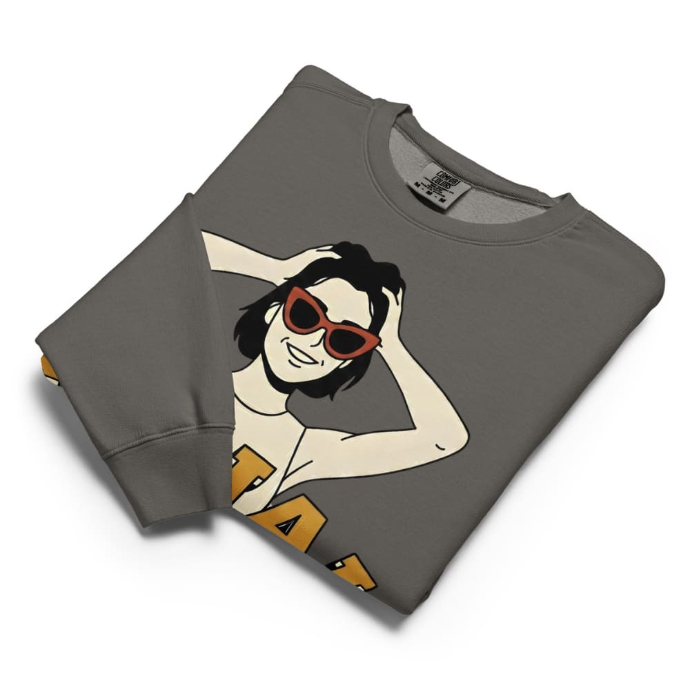 Folded gray sweatshirt with a graphic design of a person wearing sunglasses on a white background