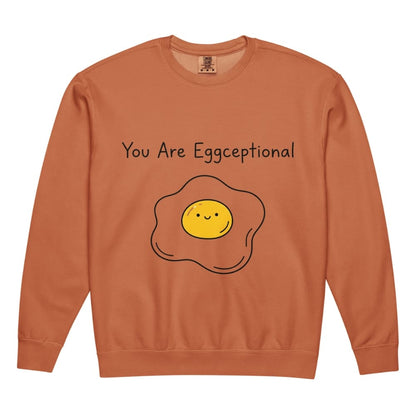 Orange sweatshirt with a smiley face egg graphic and text 'You Are Eggceptional' on a white background