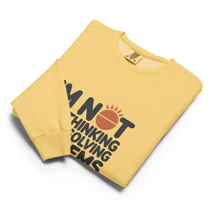 Yellow sweatshirt with black text and red circle design on a white background