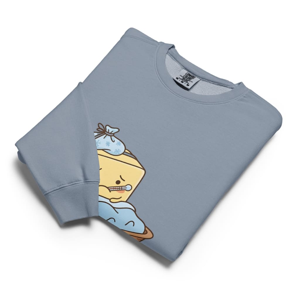 Folded light blue sweatshirt with cartoon character on a white background