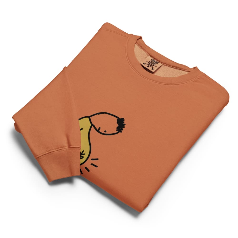 Folded orange sweatshirt with a black and yellow graphic on a white background