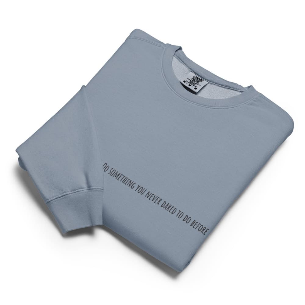 Folded light blue sweatshirt with text on a white background