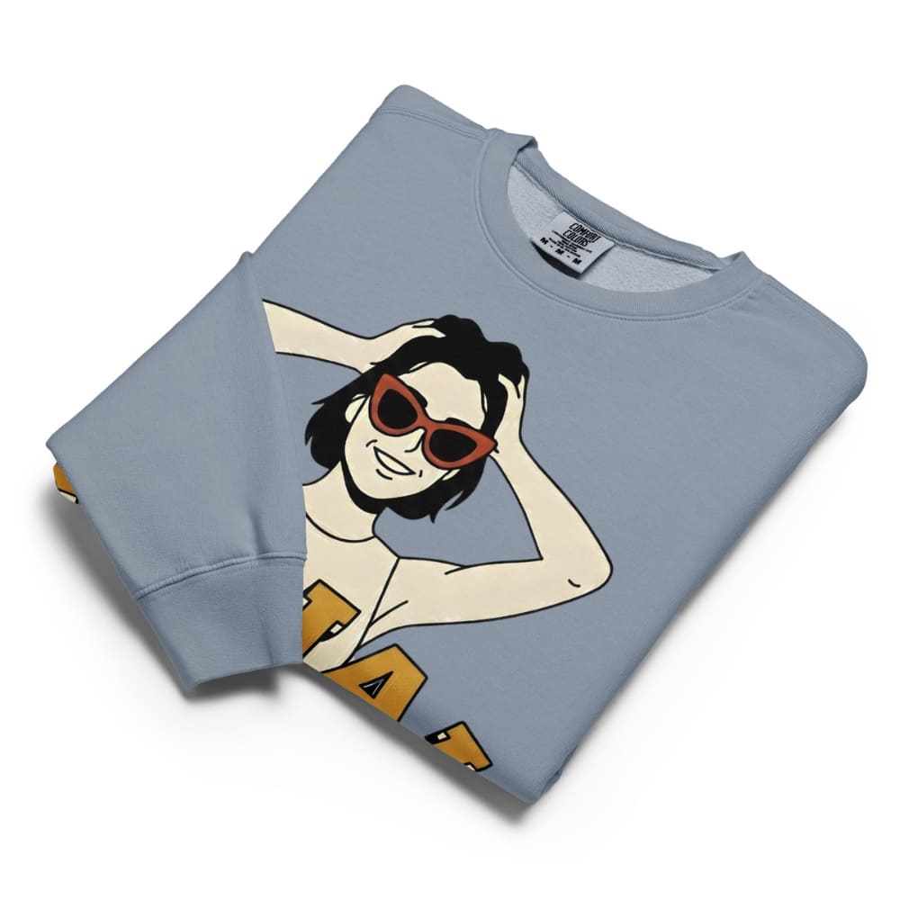 Folded light blue sweatshirt with a graphic design on a white background