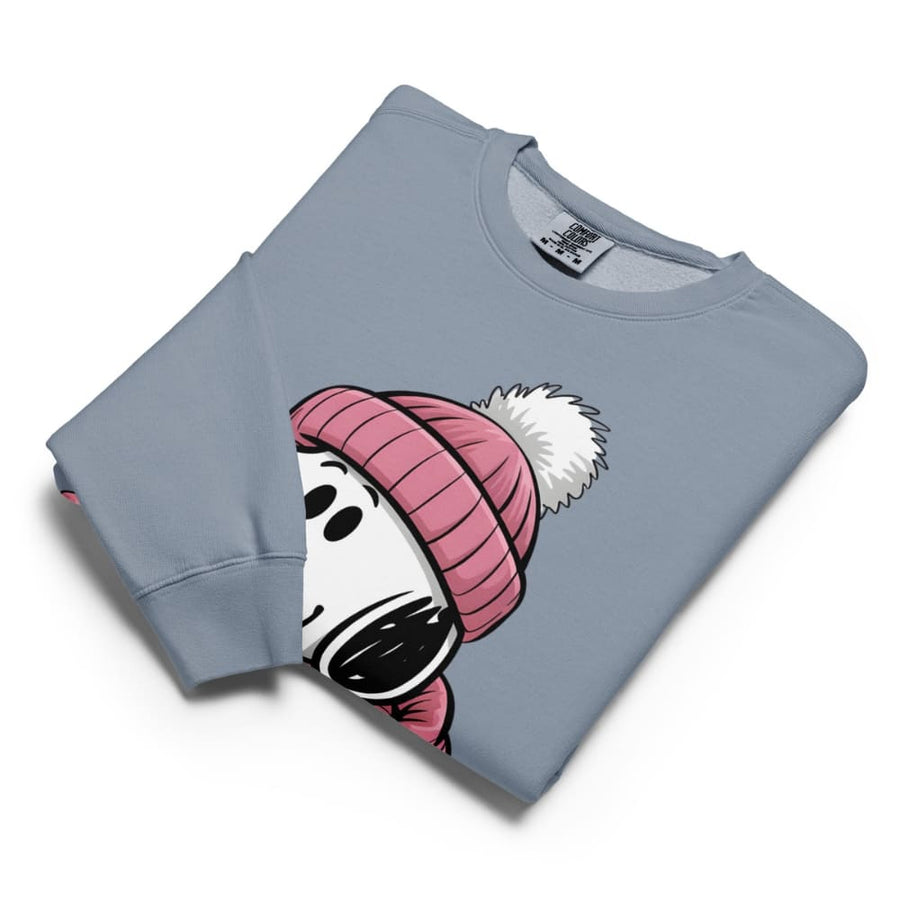 Folded blue sweatshirt with cartoon character wearing a pink beanie on a white background