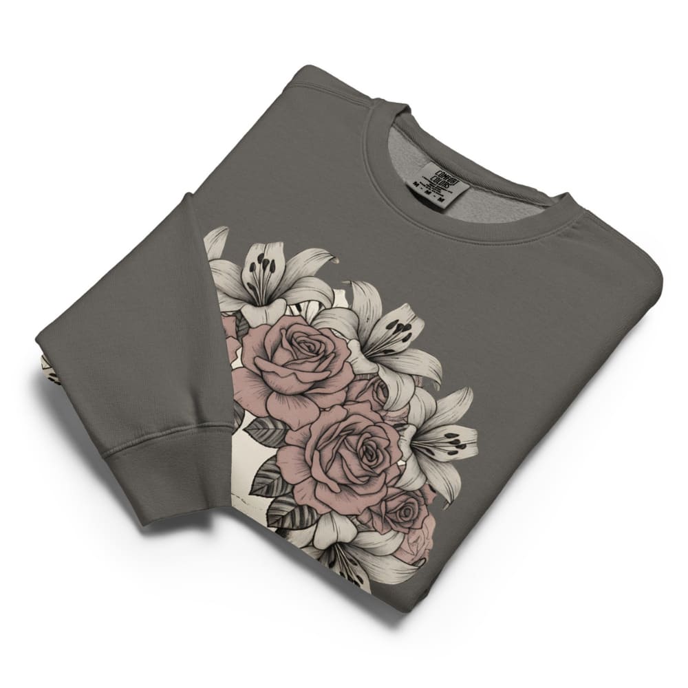 Folded gray sweatshirt with floral design on a white background