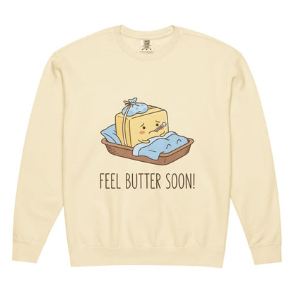 Ivory sweatshirt with a cartoon design of butter and text 'Feel Butter Soon!' on a white background