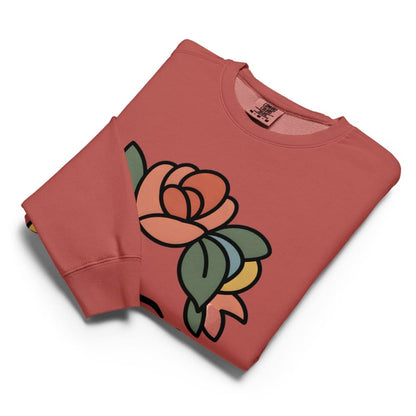 Folded red sweatshirt with a colorful rose design on a white background