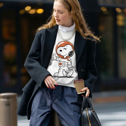 Woman wearing a Snoopy astronaut t-shirt in an urban setting