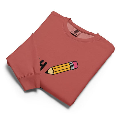 Folded red sweatshirt with a pencil graphic on a white background