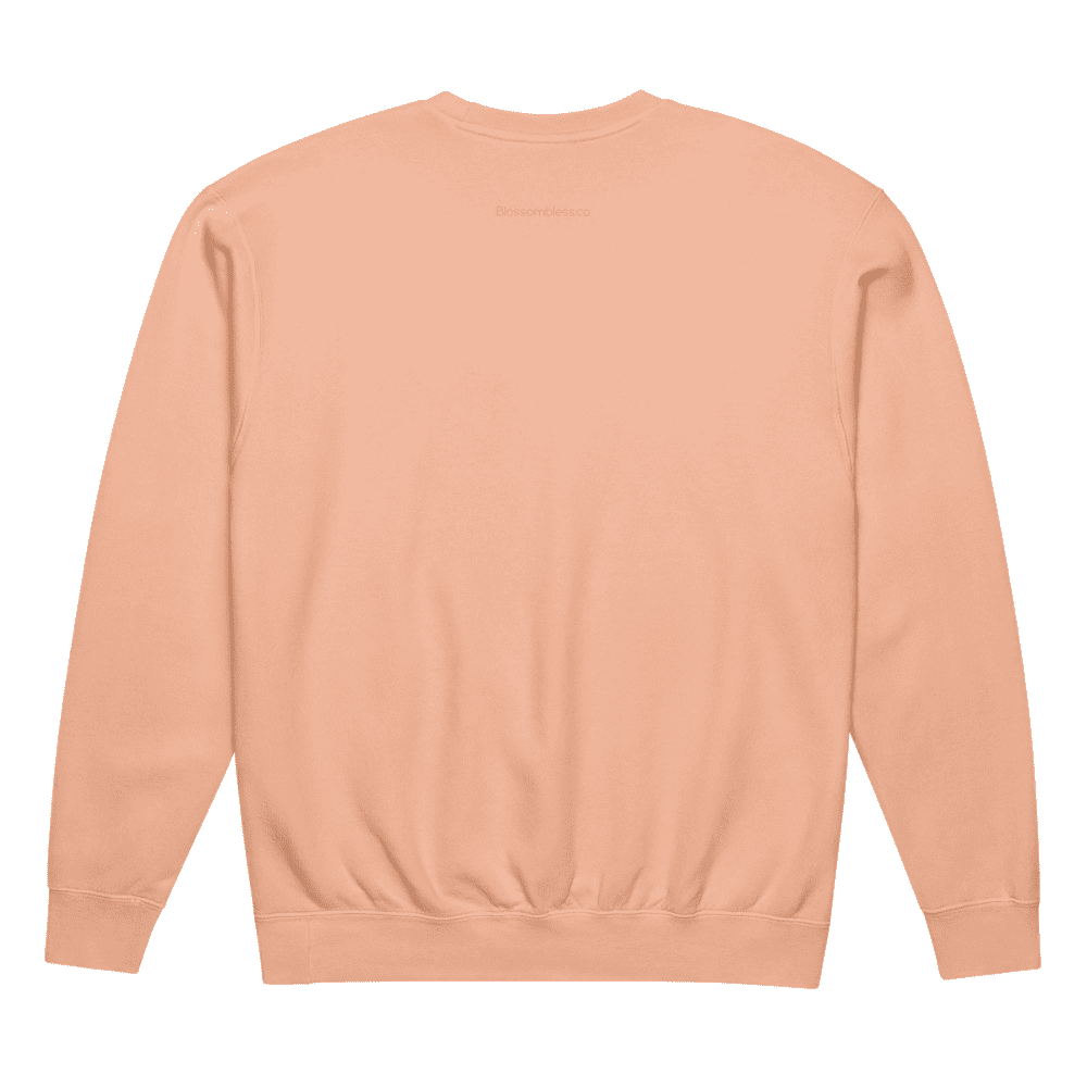 Back view of a peach-colored sweatshirt on a white background
