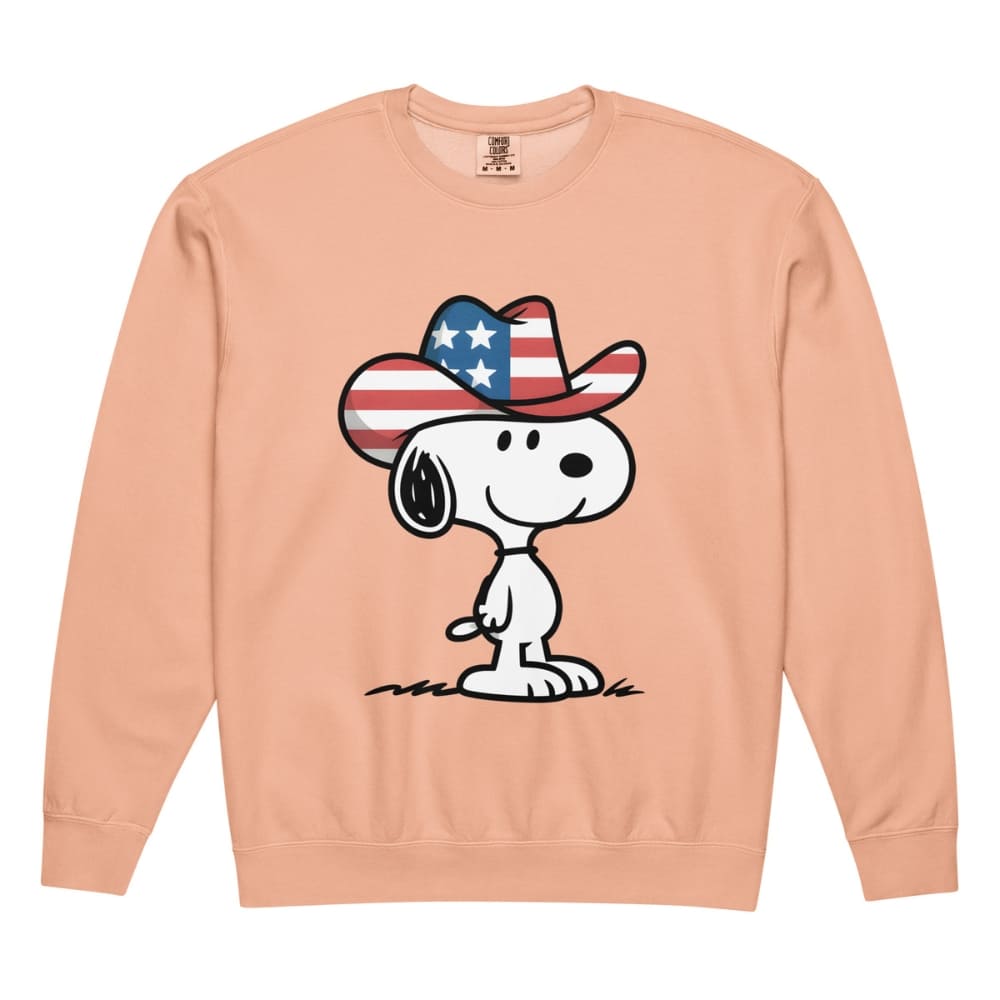 Peach sweatshirt with a cartoon dog wearing an American flag cowboy hat on a white background