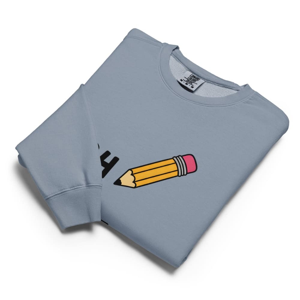 Folded blue sweatshirt with a pencil graphic on a white background