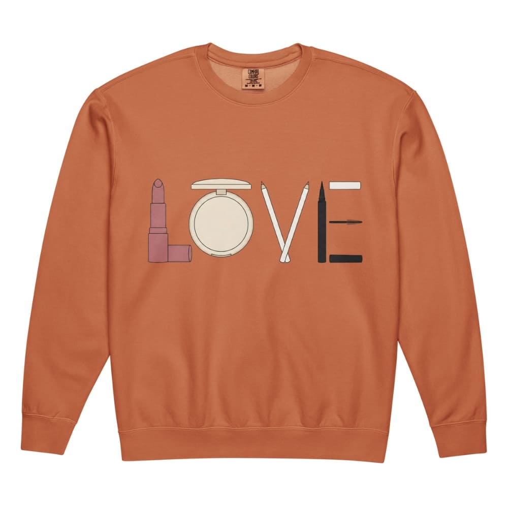 Orange sweatshirt with makeup product design spelling 'LOVE' on a white background