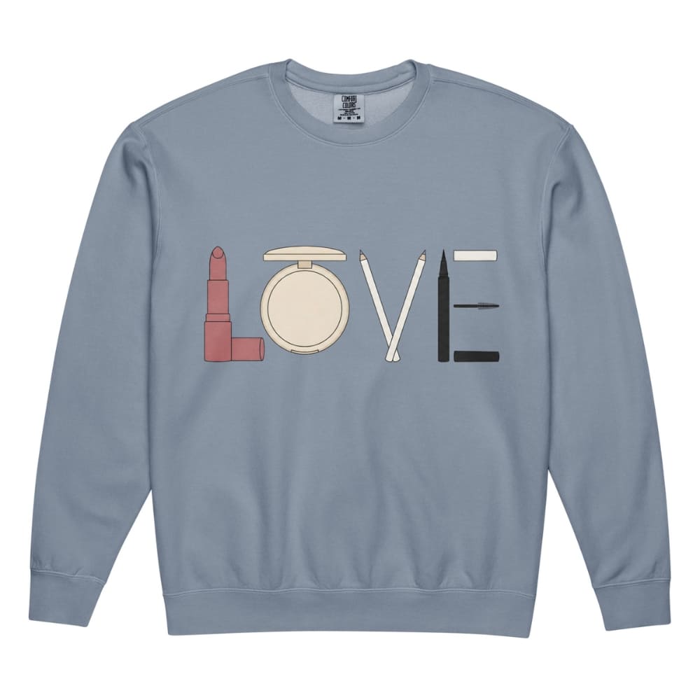 Blue sweatshirt with 'LOVE' spelled out using makeup icons on a white background