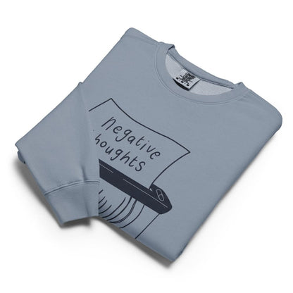 Folded light blue sweatshirt with 'negative thoughts' graphic on a white background