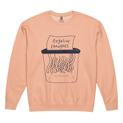 Peach-colored sweatshirt with a graphic of a paper shredder and 'negative thoughts' text on a white background