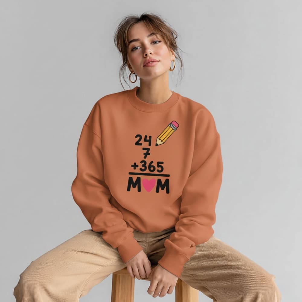 Person wearing a orange sweatshirt with a unique design on a gray background