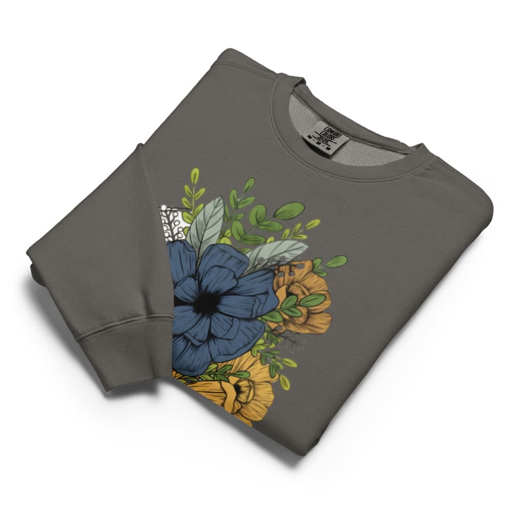 Folded gray sweatshirt with floral design on a white background