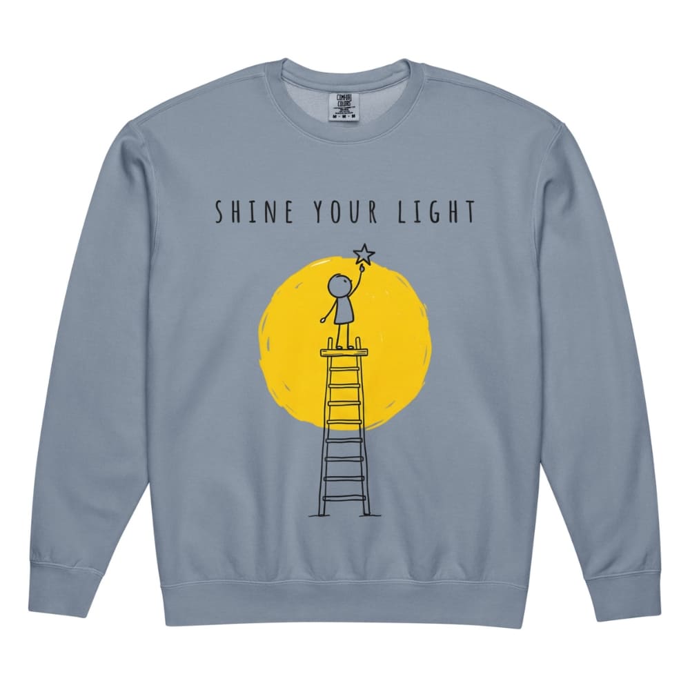 Blue sweatshirt with 'Shine Your Light' graphic on a white background