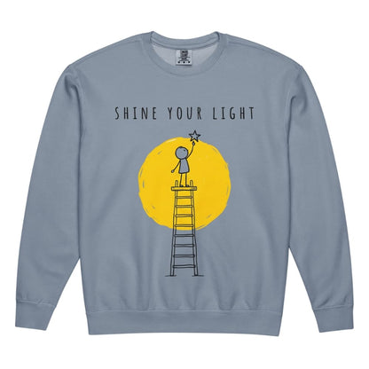Blue sweatshirt with 'Shine Your Light' graphic on a white background