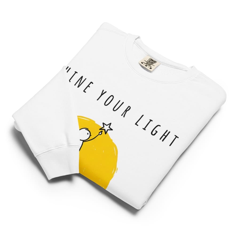 White sweatshirt with yellow lemon graphic and 'Live Your Light' text on a white background