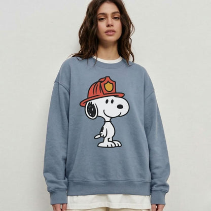 Person wearing a blue sweatshirt with a cartoon character design on a plain background
