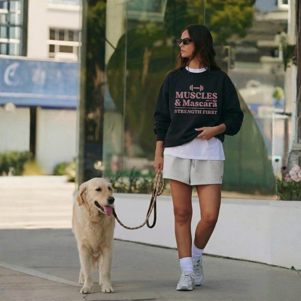 Woman walking a dog on a leash in an urban setting