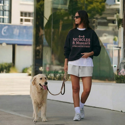 Woman walking a dog on a leash in an urban setting