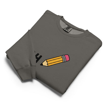 Folded gray sweatshirt with a pencil graphic on a white background